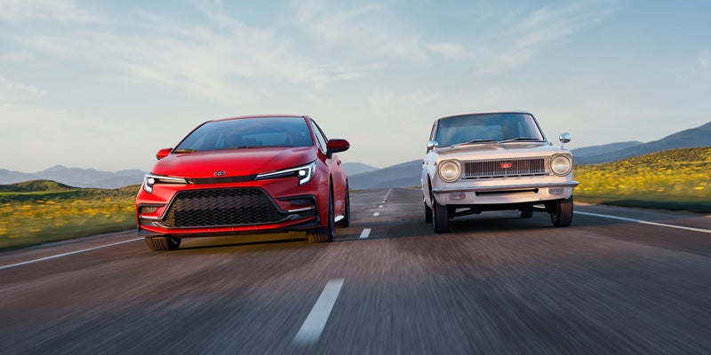 2027 Toyota Corolla 60th Anniversary Special Edition in Supersonic Red driving alongside a classic 1966 Corolla