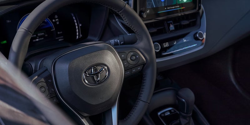 2027 Toyota Corolla steering wheel controls and driver cockpit layout