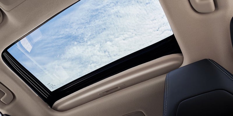 2027 Toyota Corolla sedan driving on a highway with 2.0-liter Dynamic Force engine