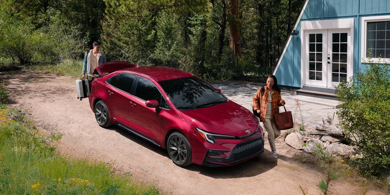 2027 Toyota Corolla parked outside with open trunk showing 13.1 cubic feet of luggage space
